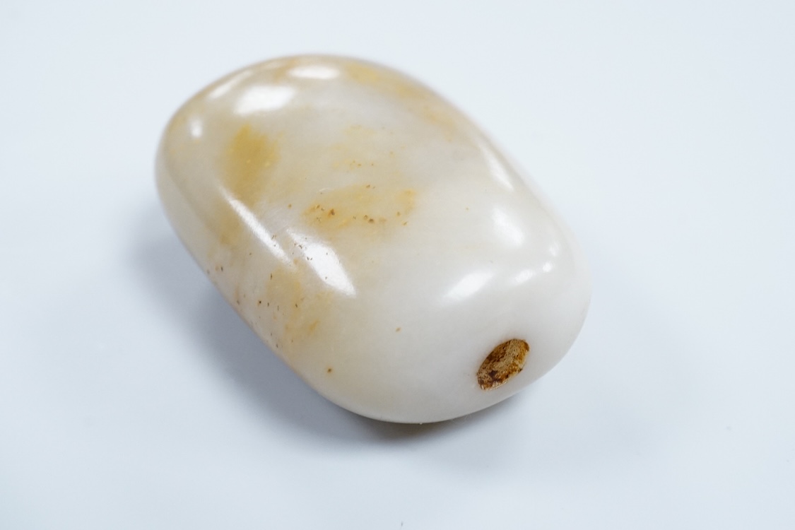 A 19th century Chinese white and russet jade pebble snuff bottle, 5.5cm in length
